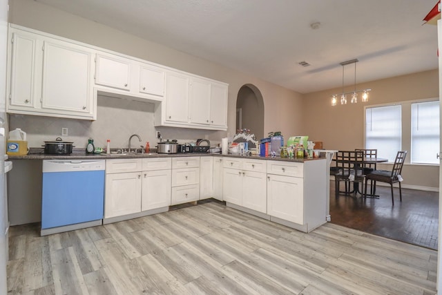 kitchen with dishwasher, light hardwood / wood-style floors, white cabinetry, and hanging light fixtures