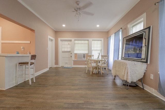 interior space with cooling unit, dark hardwood / wood-style floors, ceiling fan, and ornamental molding