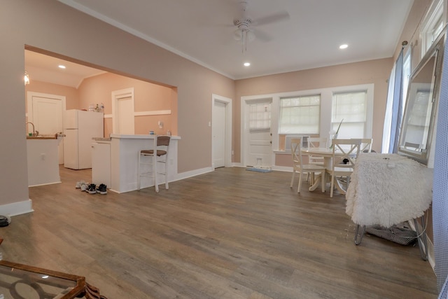 dining room with ceiling fan and dark wood-type flooring