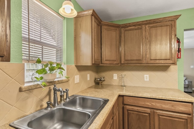 kitchen featuring tasteful backsplash and sink