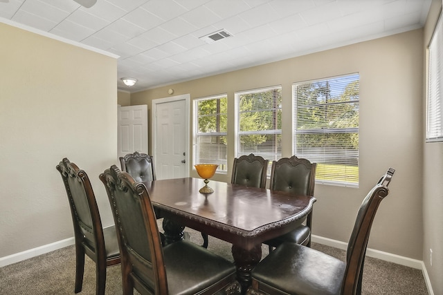 dining area featuring crown molding and carpet floors