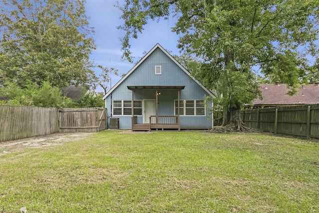 back of property featuring a yard and a wooden deck