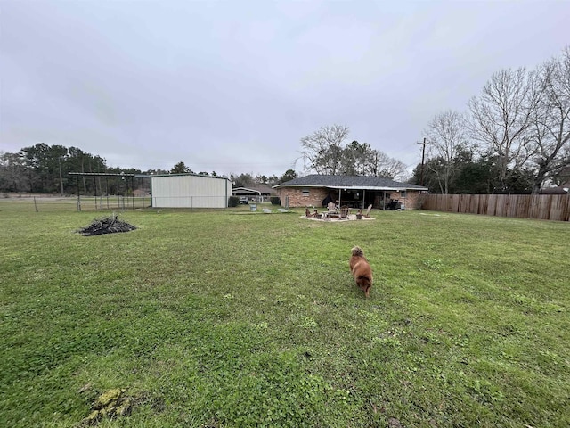 view of yard with fence and a patio