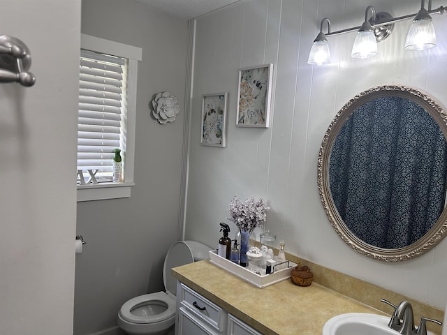 bathroom with toilet and vanity