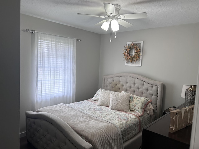 bedroom with a textured ceiling and ceiling fan