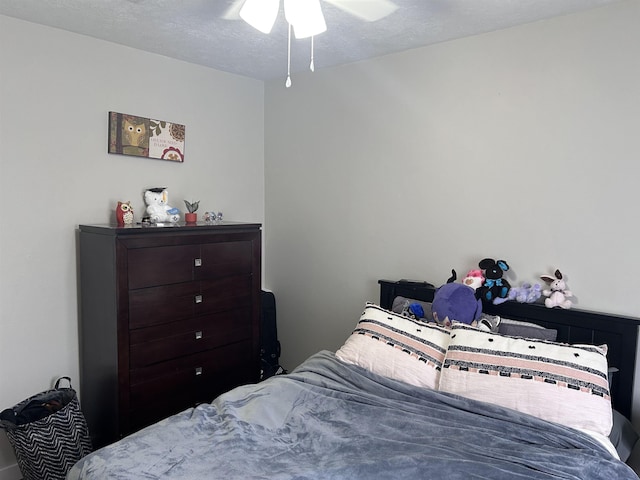 bedroom featuring a textured ceiling and a ceiling fan