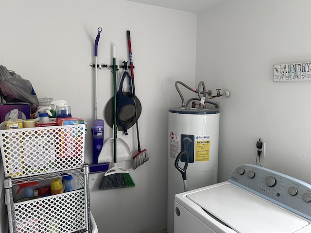 laundry area featuring laundry area, water heater, and washer / clothes dryer