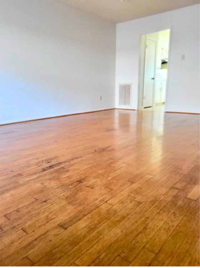 empty room with light hardwood / wood-style flooring