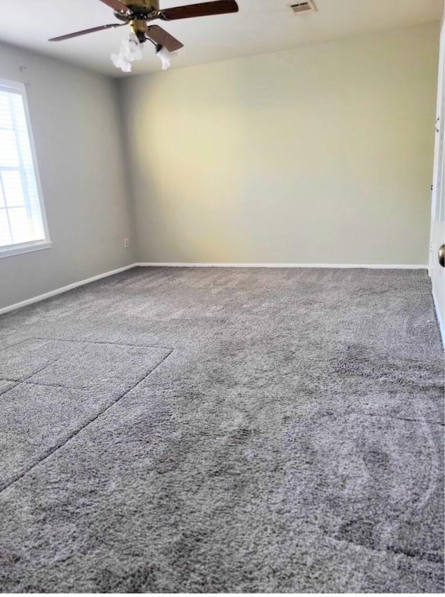 unfurnished room with ceiling fan and carpet floors