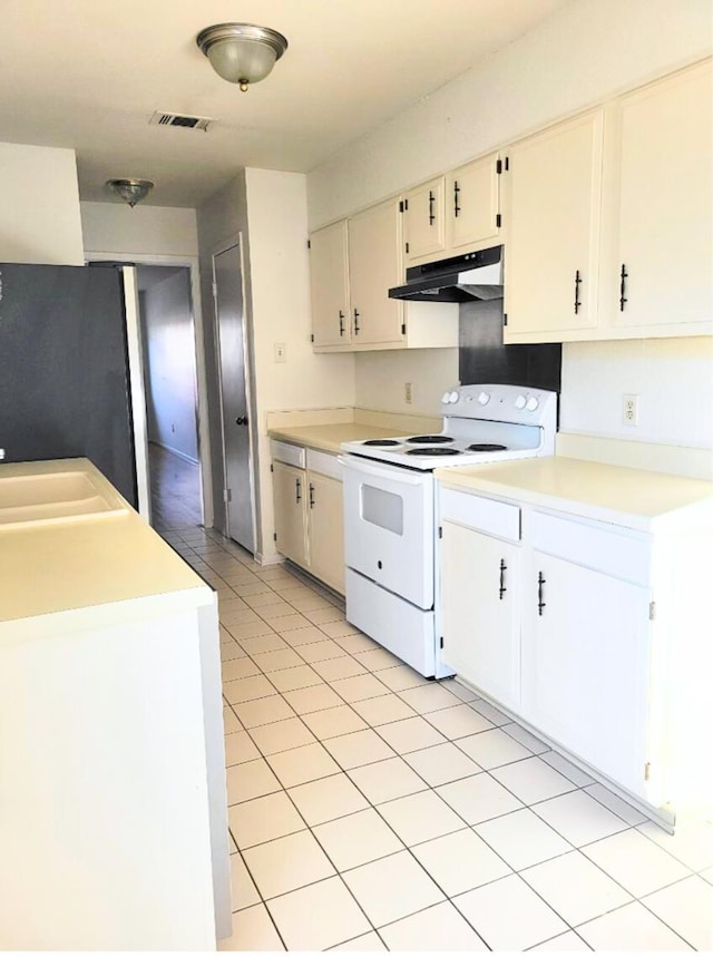 kitchen with white cabinets, electric range, fridge, and sink