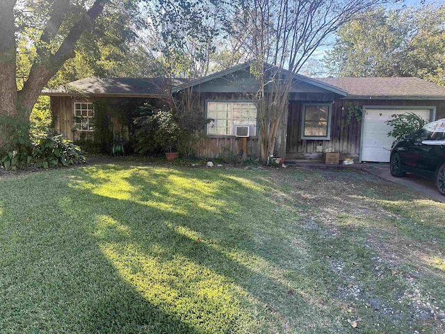 ranch-style home featuring cooling unit, a front lawn, and a garage