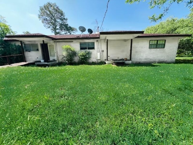 rear view of house with a yard