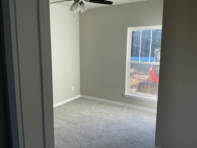 unfurnished room with ceiling fan and light carpet