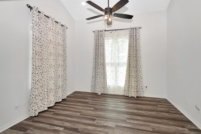 unfurnished room featuring a ceiling fan, lofted ceiling, wood finished floors, and baseboards