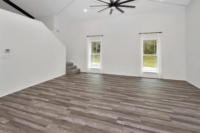 unfurnished living room featuring recessed lighting, stairs, baseboards, and wood finished floors