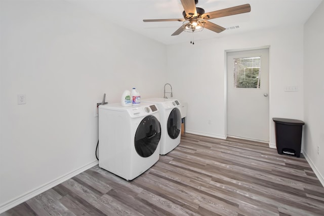 laundry room featuring visible vents, washer and dryer, light wood-style floors, baseboards, and laundry area