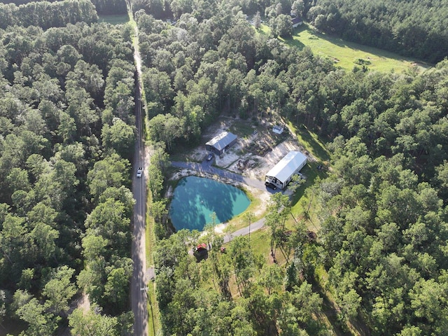 birds eye view of property featuring a wooded view