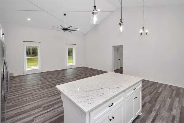 kitchen featuring a kitchen island, open floor plan, high vaulted ceiling, dark wood-style floors, and white cabinetry