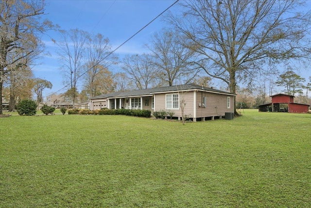 rear view of house featuring a lawn