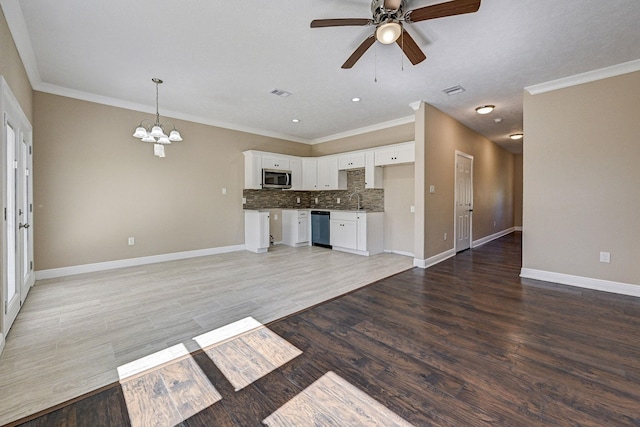 450 Jackson St, Beaumont, TX 77701 - unfurnished living room with ceiling fan, a chandelier, baseboards, ornamental molding, and light wood-type flooring