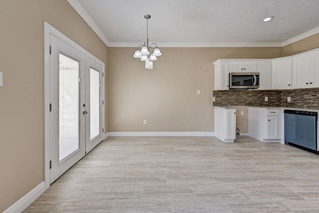 450 Jackson St, Beaumont, TX 77701 - kitchen with dishwasher, stainless steel microwave, a chandelier, plenty of natural light, and crown molding