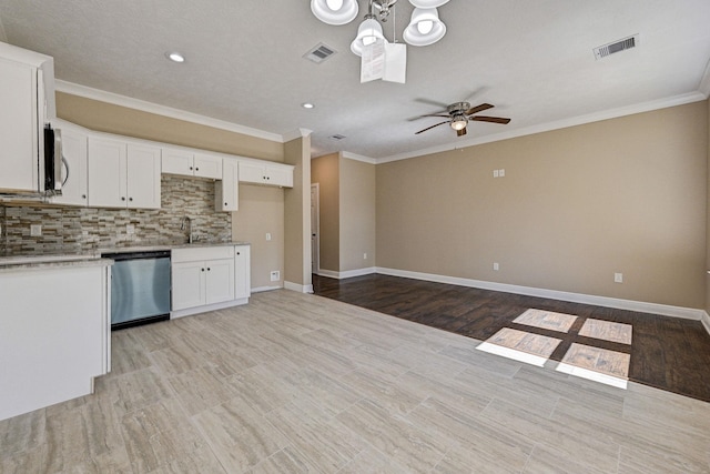 450 Jackson St, Beaumont, TX 77701 - kitchen with stainless steel dishwasher, a ceiling fan, backsplash, white cabinetry, and crown molding