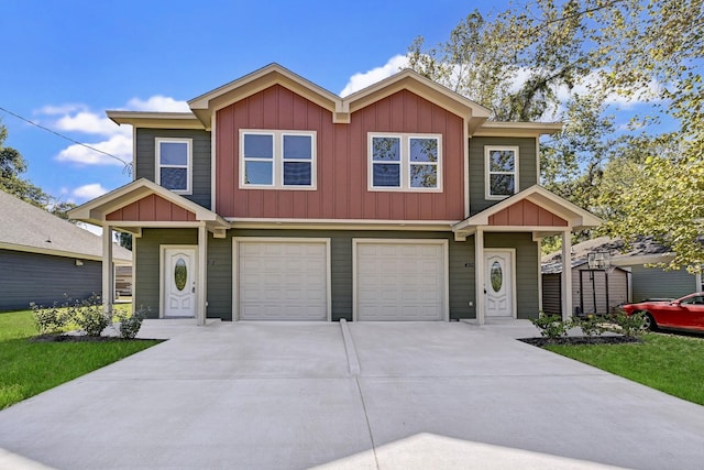 450 Jackson St, Beaumont, TX 77701 - view of front facade with board and batten siding, driveway, an attached garage, and a storage shed