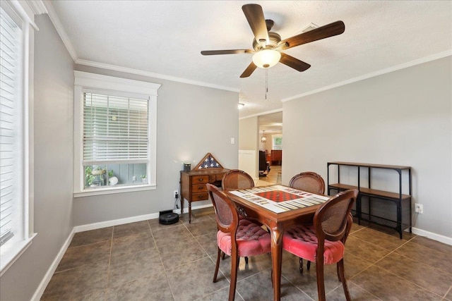 tiled dining area with ornamental molding, ceiling fan, and baseboards