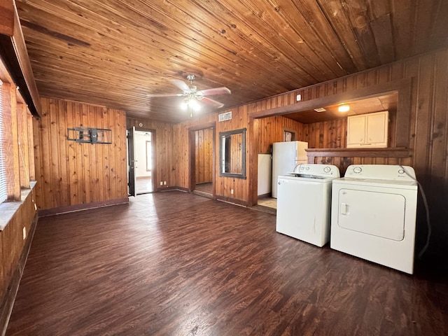 washroom featuring cabinets, wood ceiling, washer and dryer, dark hardwood / wood-style floors, and wood walls