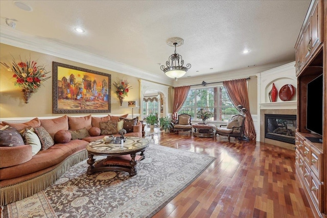 7510 Shadow Creek Dr, Beaumont, TX 77707 - living area featuring hardwood / wood-style floors, a fireplace, ornamental molding, recessed lighting, and a textured ceiling