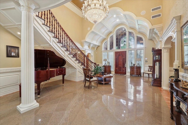 7510 Shadow Creek Dr, Beaumont, TX 77707 - entrance foyer featuring ornate columns, a towering ceiling, a decorative wall, plenty of natural light, and stairs