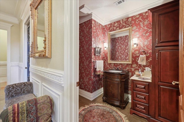 7510 Shadow Creek Dr, Beaumont, TX 77707 - half bathroom with crown molding, vanity, a wainscoted wall, wallpapered walls, and a decorative wall