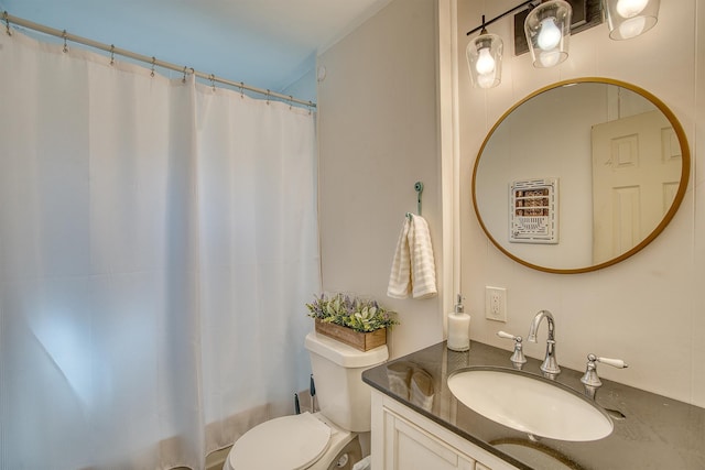 bathroom with walk in shower, vanity, and toilet