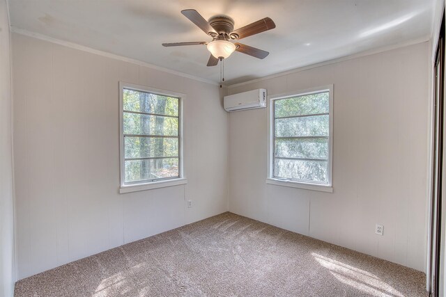 empty room featuring carpet flooring, ceiling fan, crown molding, and a wall unit AC