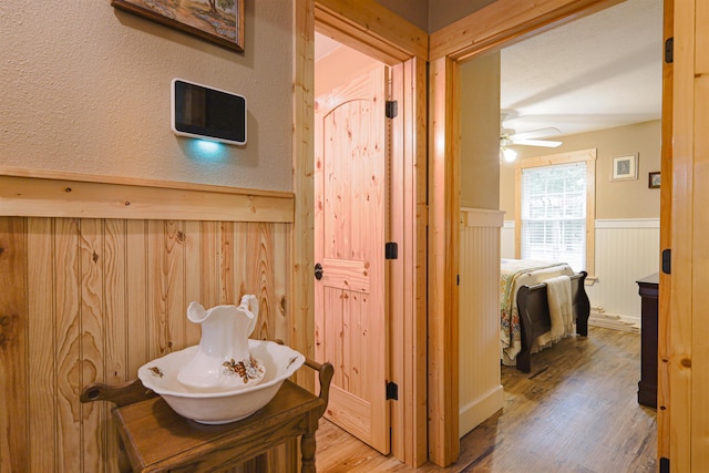 bathroom with wood-type flooring, vanity, and ceiling fan