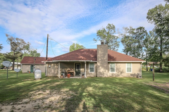 back of house featuring a patio area and a yard