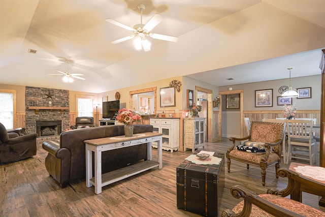 living room featuring ceiling fan, a fireplace, hardwood / wood-style floors, and lofted ceiling