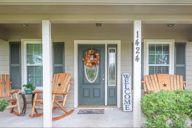 view of exterior entry with covered porch