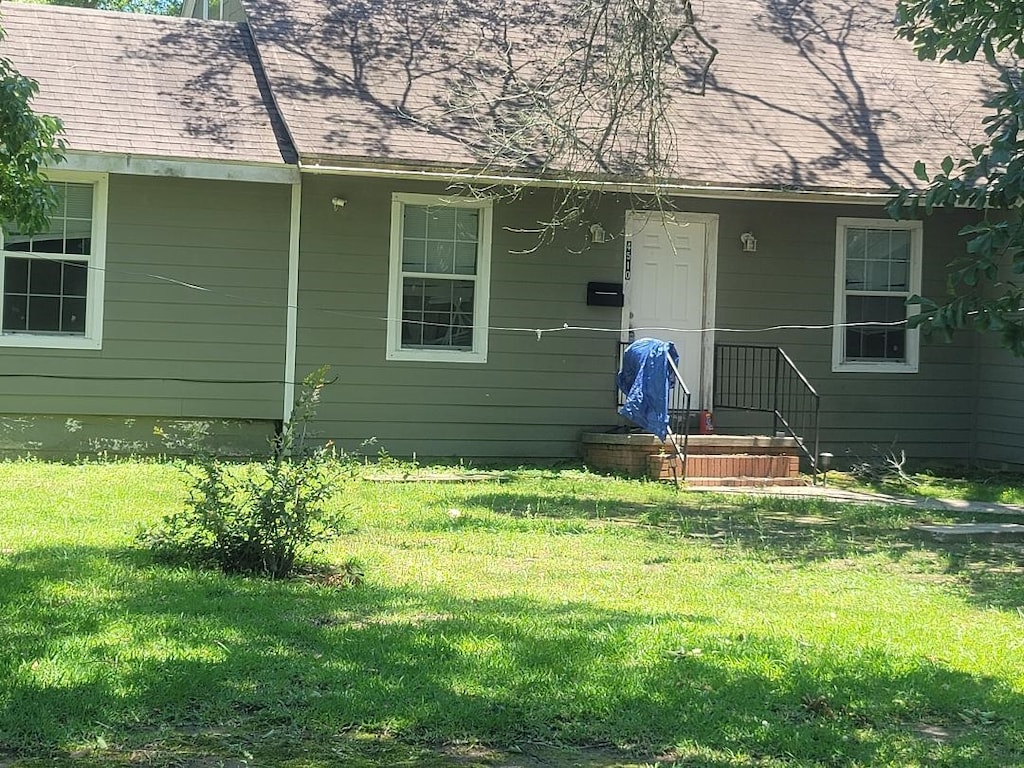 doorway to property with a yard