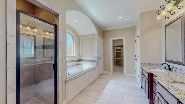 full bath with a garden tub, vanity, ornamental molding, a stall shower, and a walk in closet