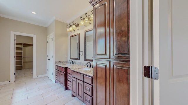 bathroom featuring crown molding, tile patterned floors, a sink, and double vanity