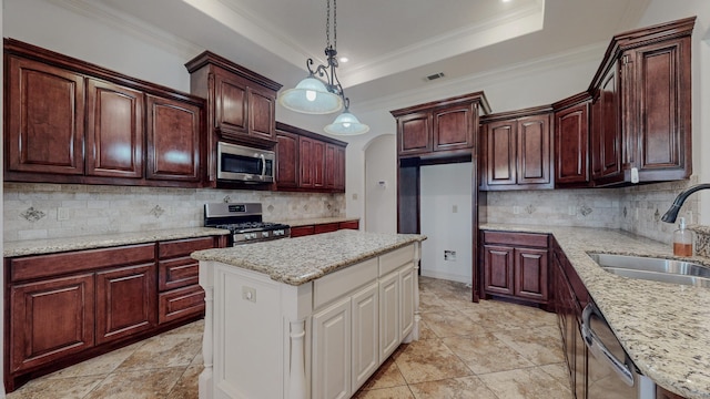 kitchen with arched walkways, a sink, visible vents, appliances with stainless steel finishes, and a tray ceiling