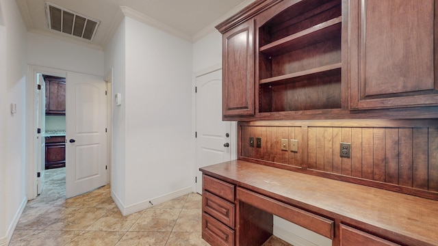 office with light tile patterned floors, baseboards, visible vents, and ornamental molding