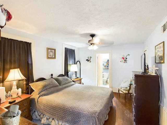 2241 4th St, Port Arthur, TX 77640 - bedroom with dark wood-type flooring, a ceiling fan, and a textured ceiling