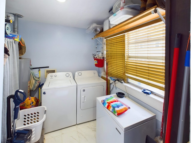 2241 4th St, Port Arthur, TX 77640 - laundry area featuring washer and clothes dryer, light marble finish floors, and water heater
