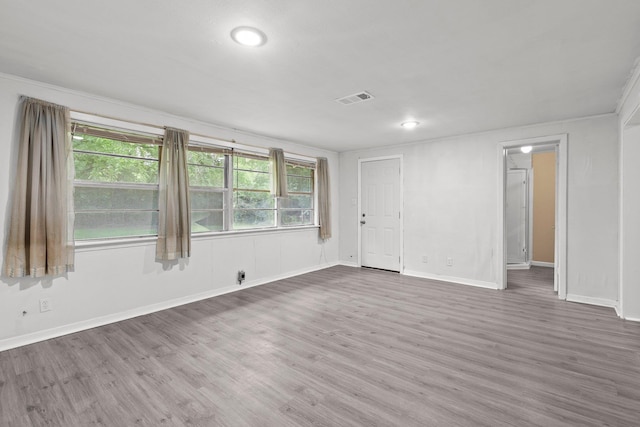 empty room with recessed lighting, baseboards, visible vents, and wood finished floors