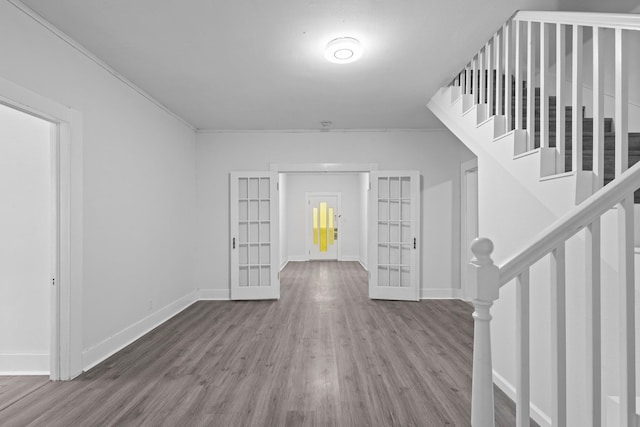 entryway featuring baseboards, french doors, stairs, and wood finished floors