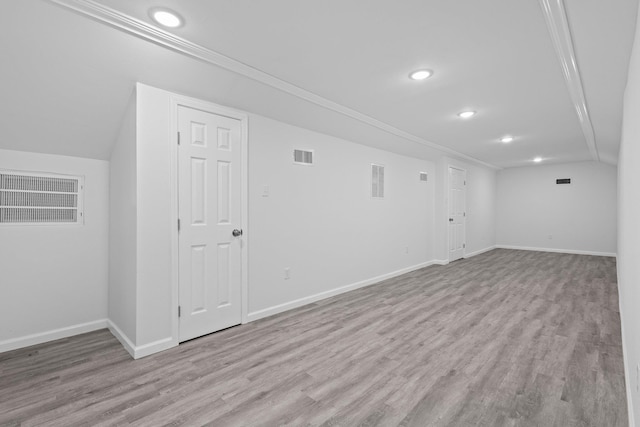 basement featuring baseboards, recessed lighting, wood finished floors, and visible vents