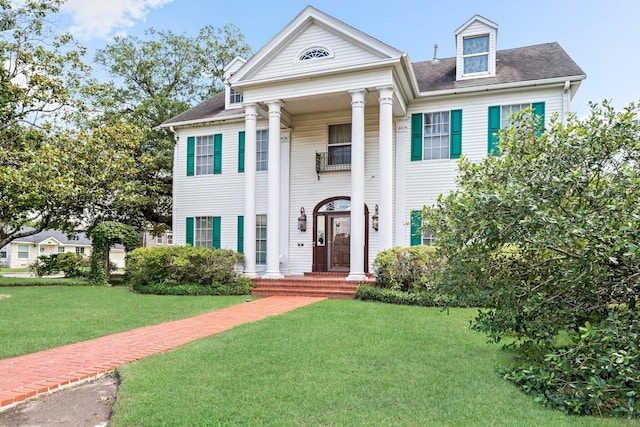 greek revival house with a front yard