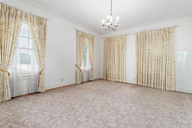 spare room with a notable chandelier and ornamental molding